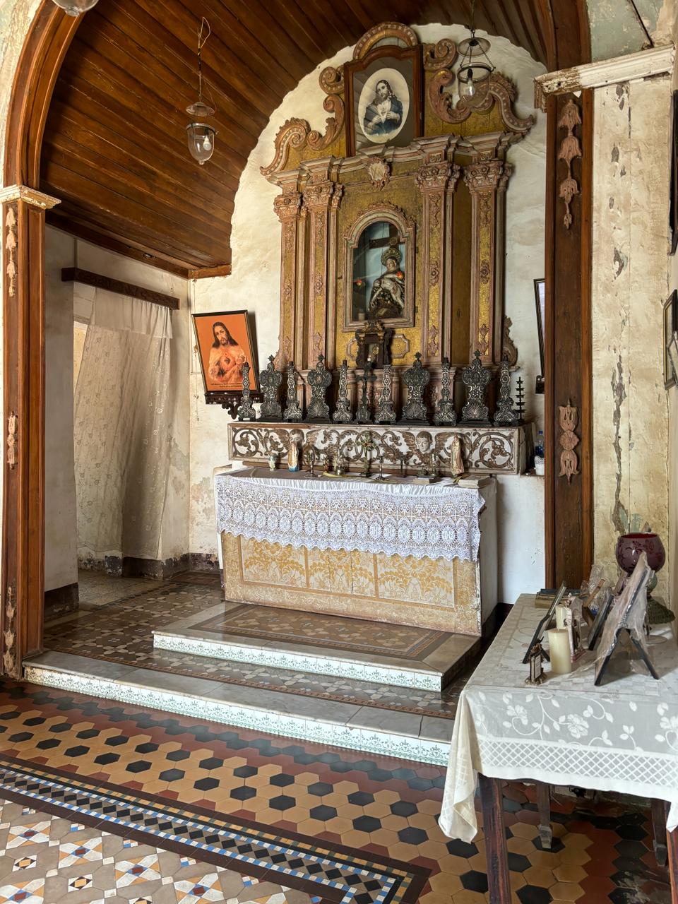 A peaceful corner of the chapel filled with religious artifacts and a small altar, inviting moments of quiet reflection and prayer.