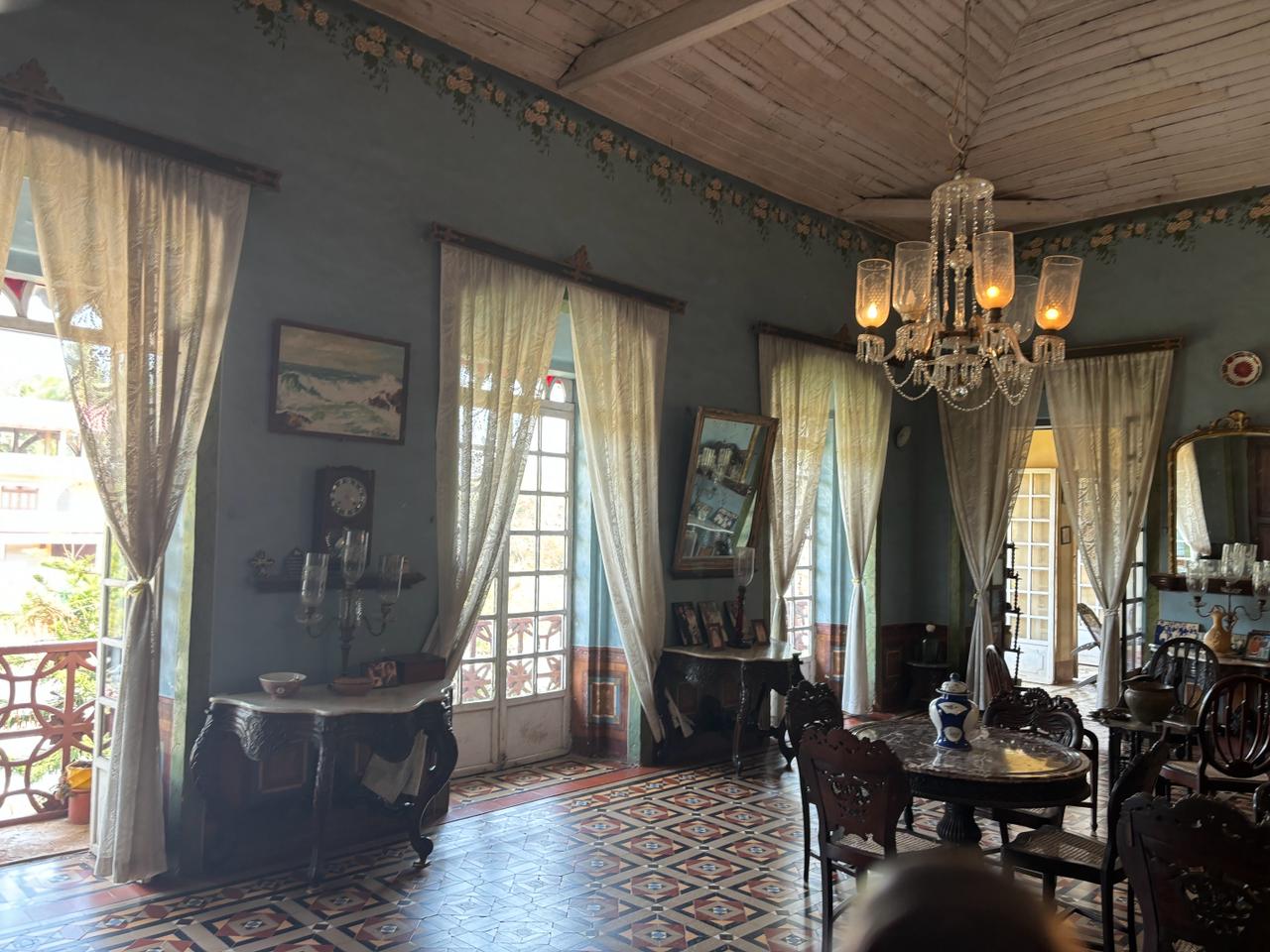 Elegant entrance area featuring seating arrangements and various artifacts, reflecting the rich heritage of Braganza House.