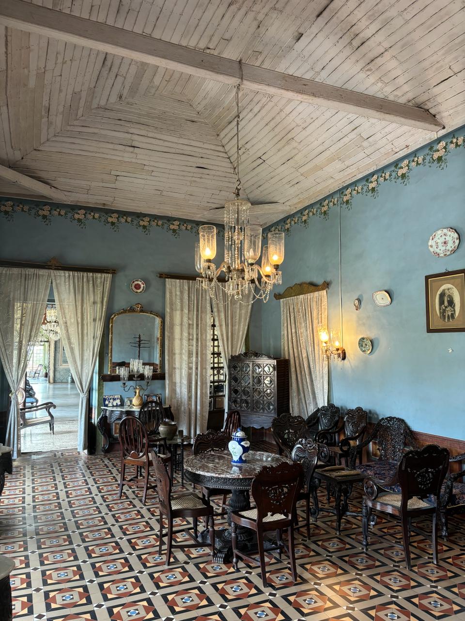 Stylish entrance displaying tables with curated artifacts, enhancing the elegance of Braganza House.