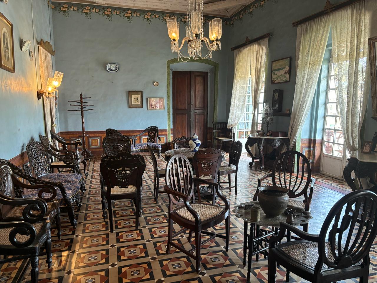 Cozy entrance space with chairs and decorative artifacts, blending comfort and history at Braganza House.