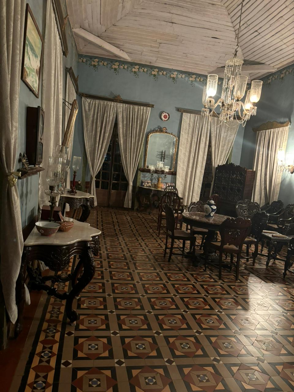 Inviting entrance area featuring comfortable chairs and a collection of decorative artifacts, seamlessly merging warmth and heritage at Braganza House.