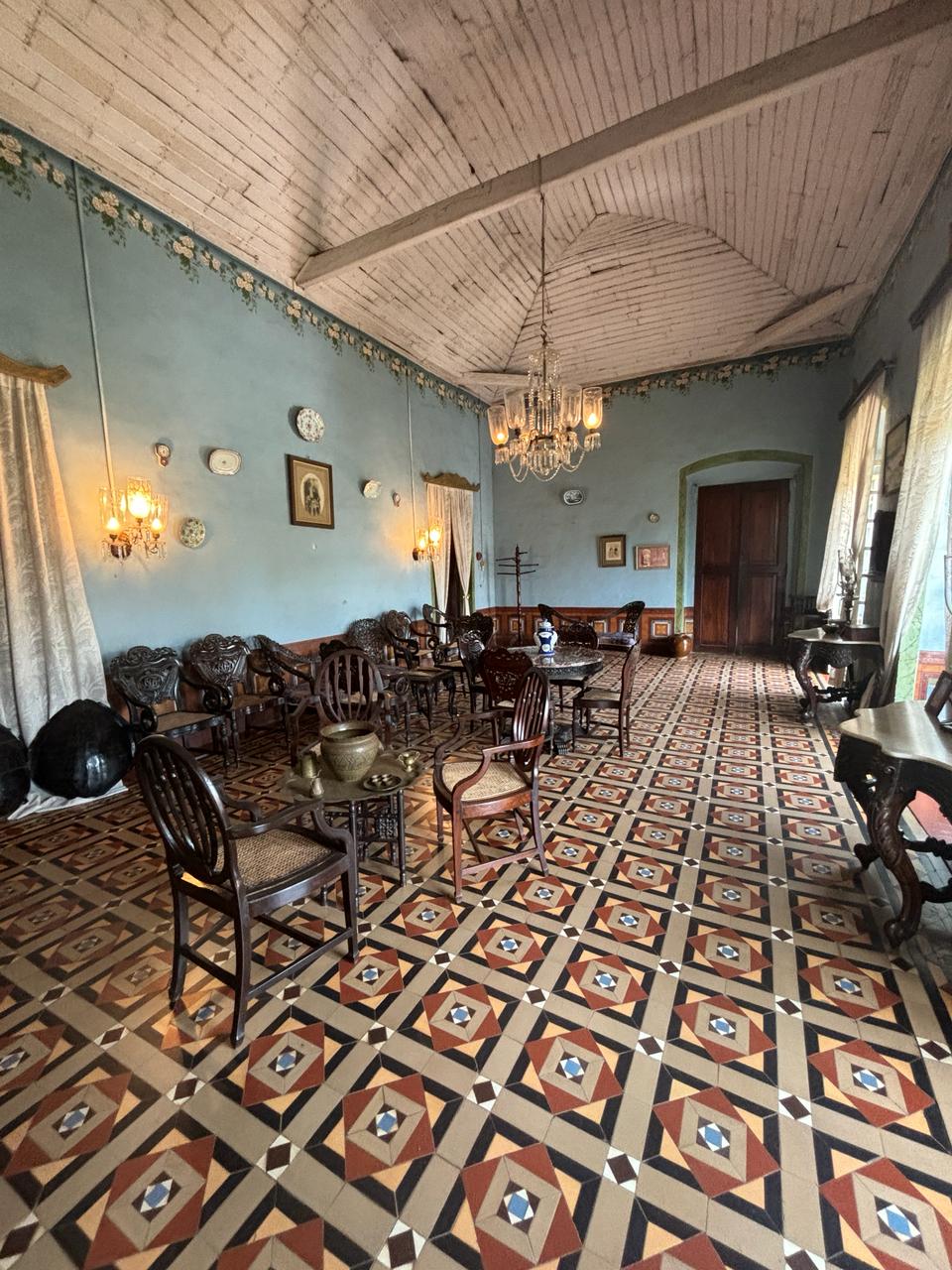 Welcoming entrance area featuring tables adorned with artifacts, creating an inviting atmosphere at Braganza House.